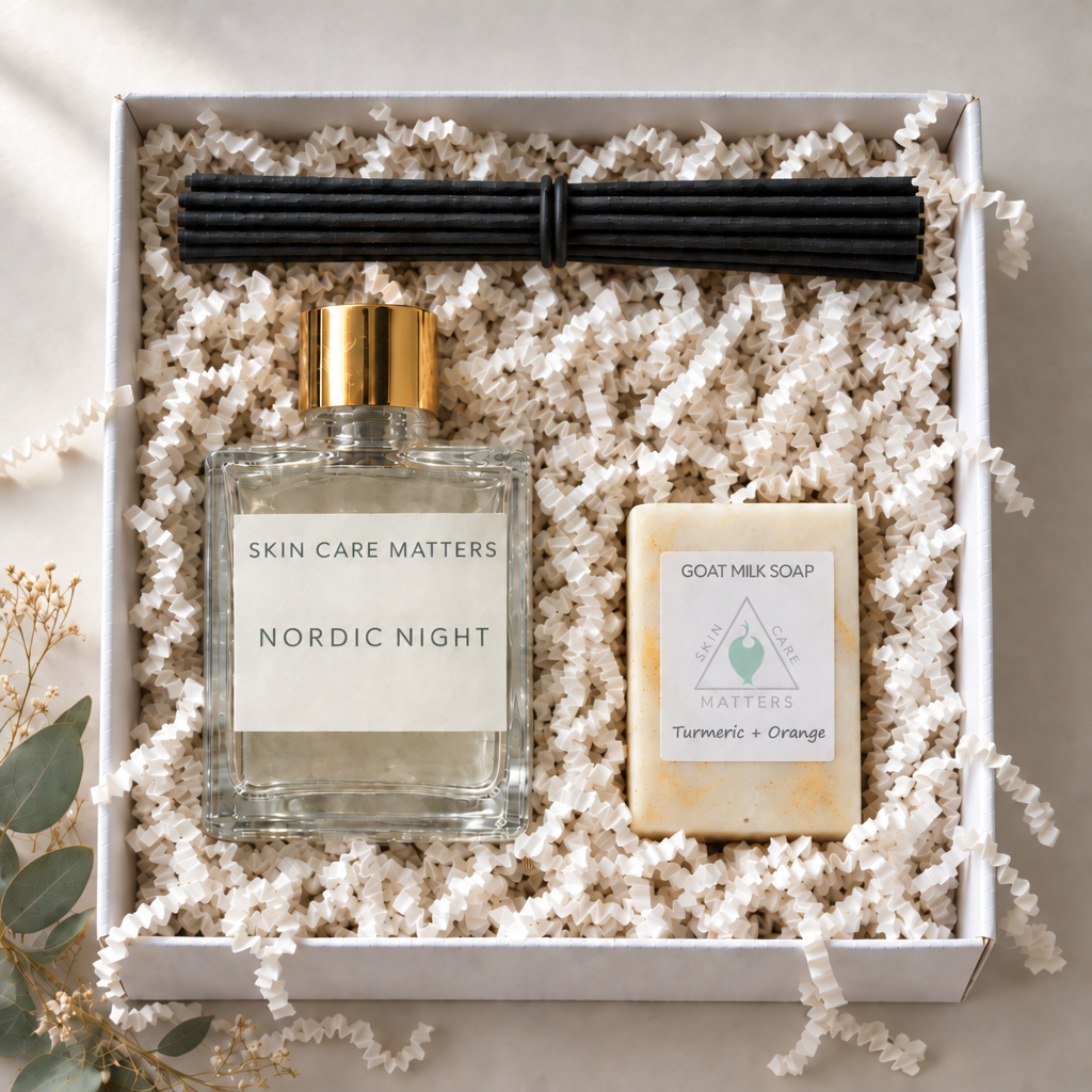 Nordic Night reed diffuser with gold cap and a turmeric-orange soap bar nestled in a white gift box